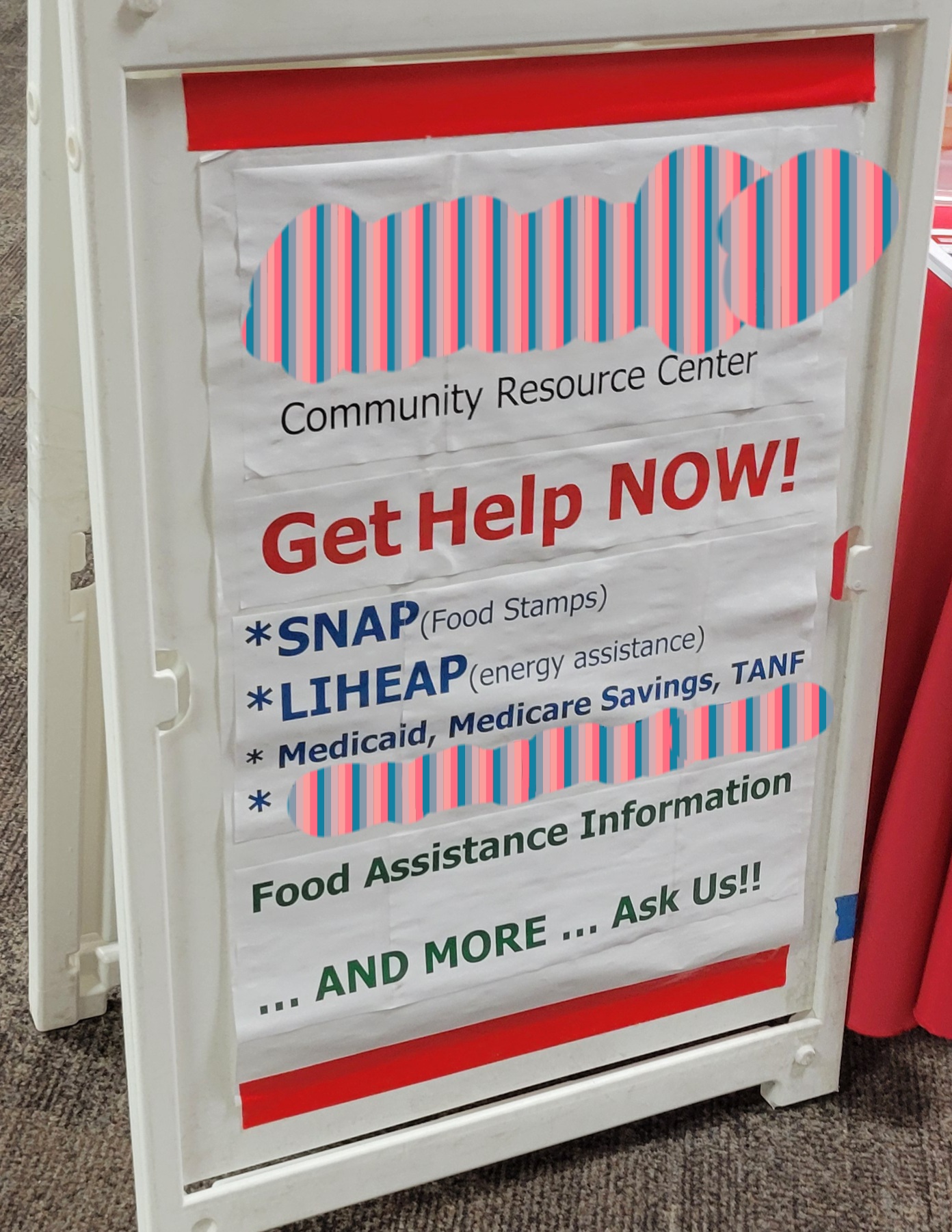 Sign board for community resource center listing what programs they can help you with and more.